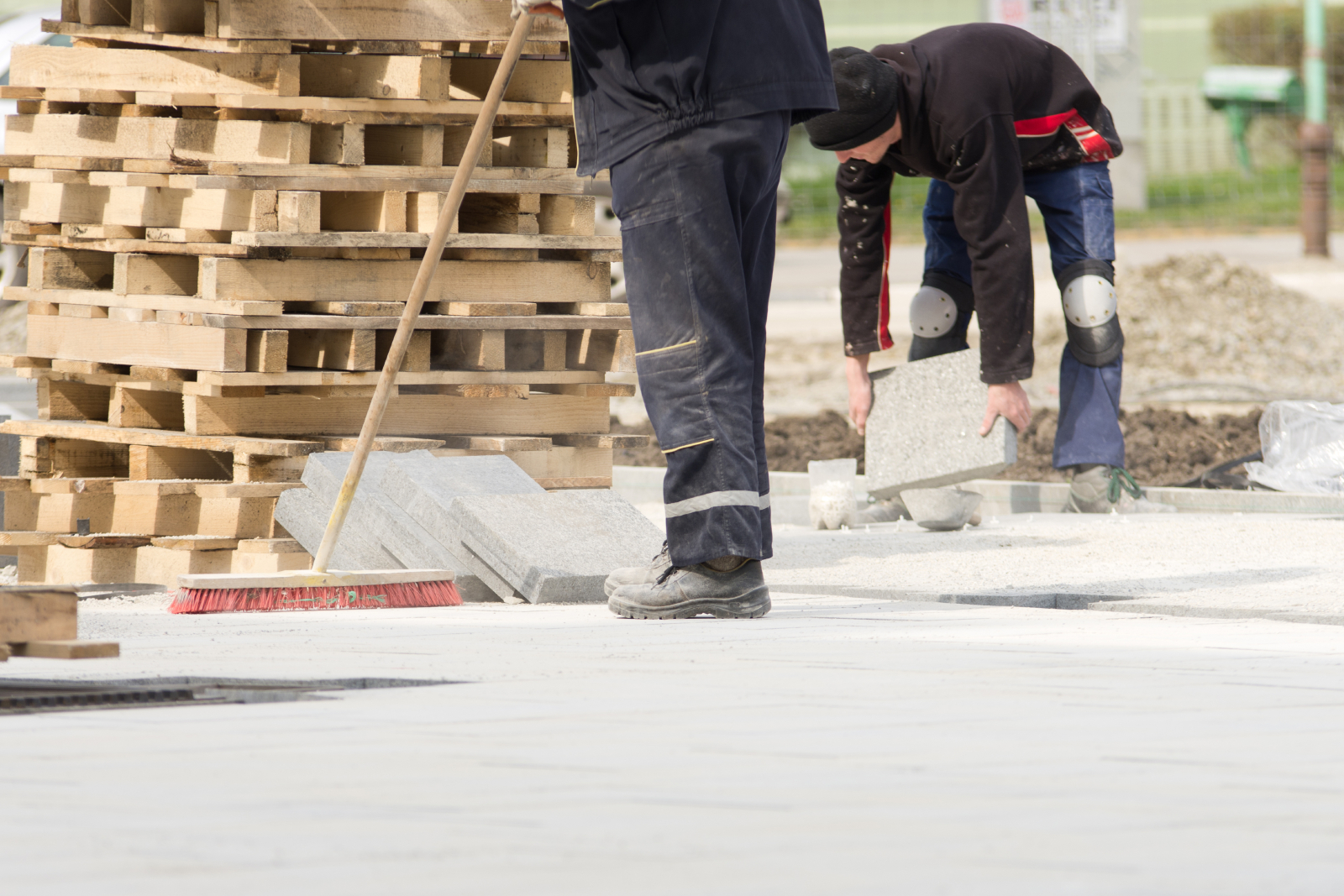 Image showing construction site workers sweeping and tidying up materials