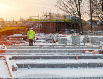 Construction site featuring one person working in wintery conditions