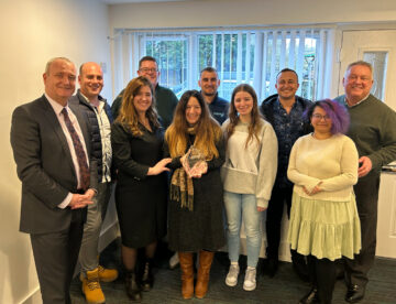 Image of team members from Sheriff Construction (office and site staff) receiving an award from IKO’s Group Managing Director and Area Business Manager