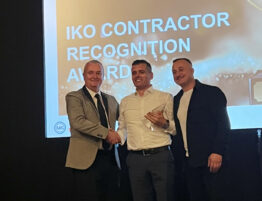 Image showing Sheriff team members receiving IKO award on stage at a ceremony event