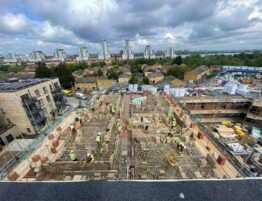 Image showing Sheriff Construction workers on a site using the G decking safety system at heights with a London city skyline in the background.