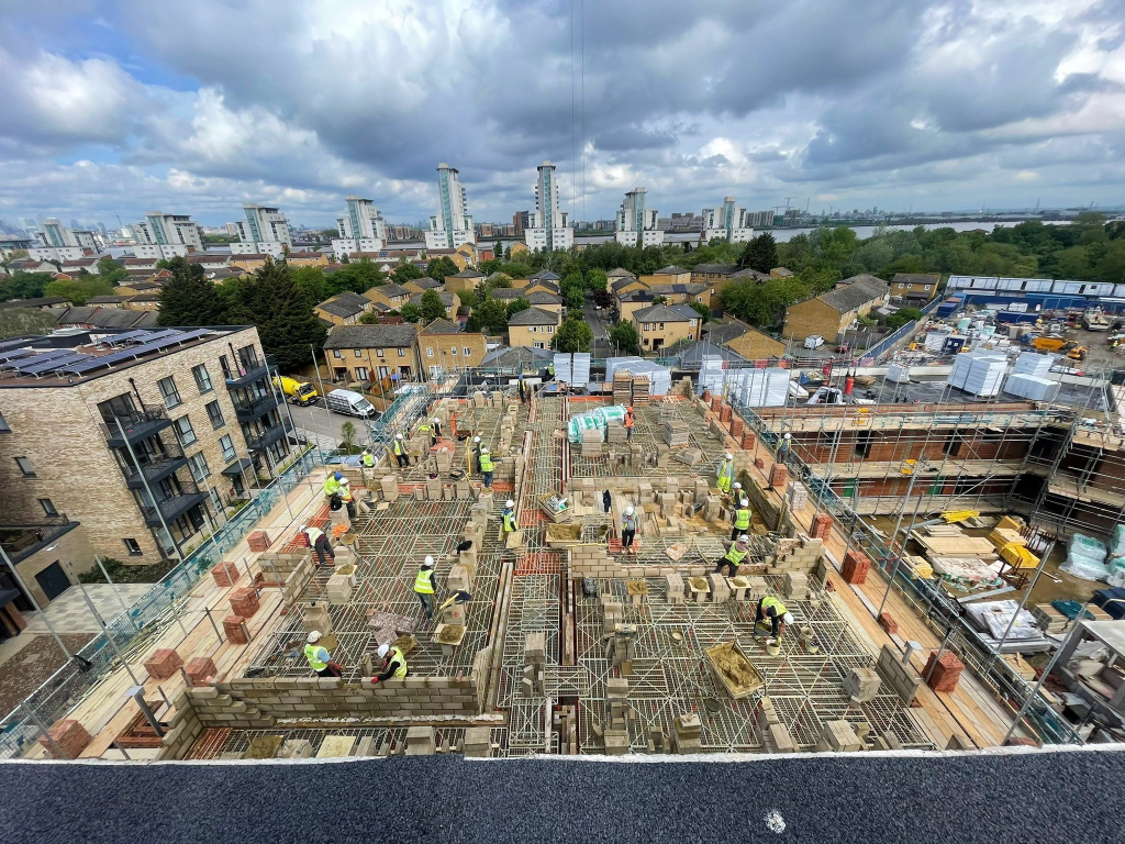 Image showing Sheriff Construction workers on a site using the G decking safety system at heights with a London city skyline in the background.