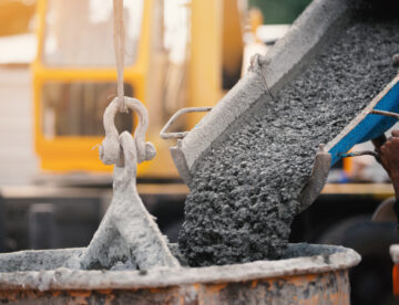 Images showing concrete being poured into a crane bucket