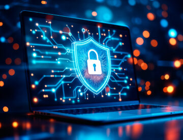 An open laptop with a big padlock image on its screen plus network pathways all in shades of blue to represent cyber security