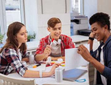 Image showing three young people working at a table in an office environment