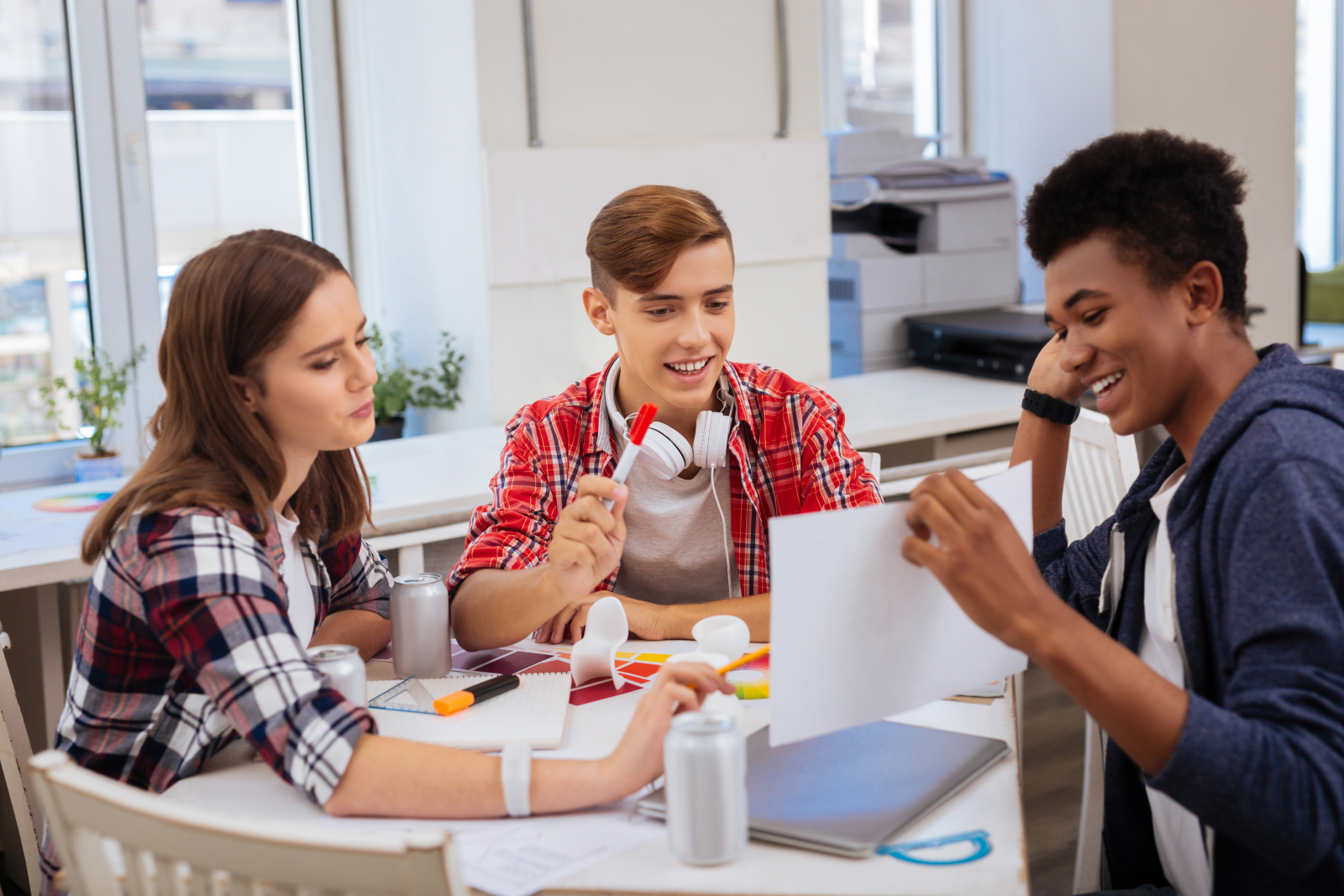 Image showing three young people working at a table in an office environment