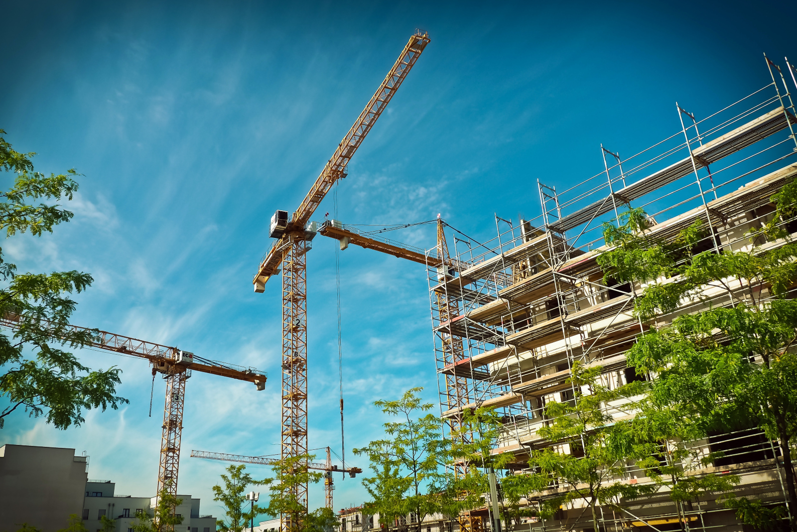 Image of a construction site with lots of cranes