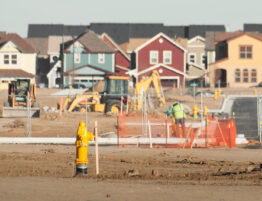 Construction site in development with some completed houses in the background