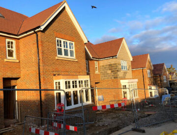 Row of houses at an almost complete stage but still with some building works taking place.