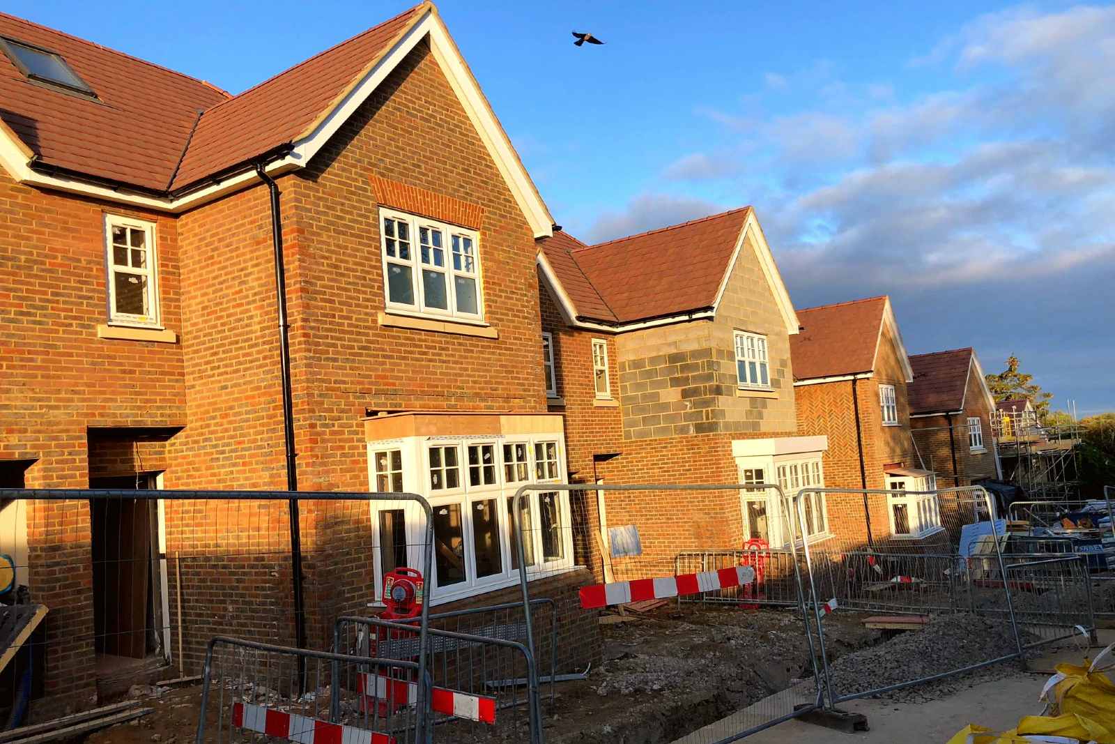 Row of houses at an almost complete stage but still with some building works taking place.