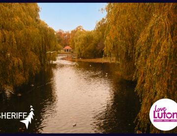 Wardown park in Luton showing the River Lea. Logos for Sheriff Construction and Love Luton also feature
